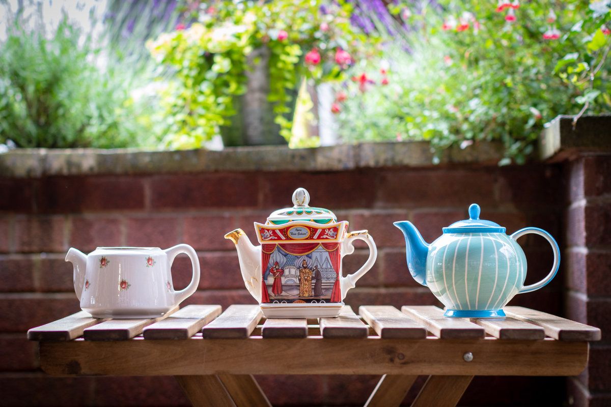 Selection of quirky, vintage china Tea Pots on a table at the Tea Room in Knutsford